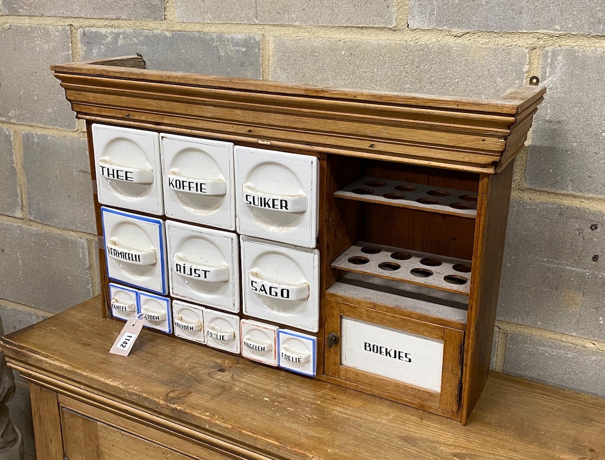 An early 20th century Dutch pine kitchen cabinet with ceramic drawers, width 75cm, depth 19cm, height 47cm